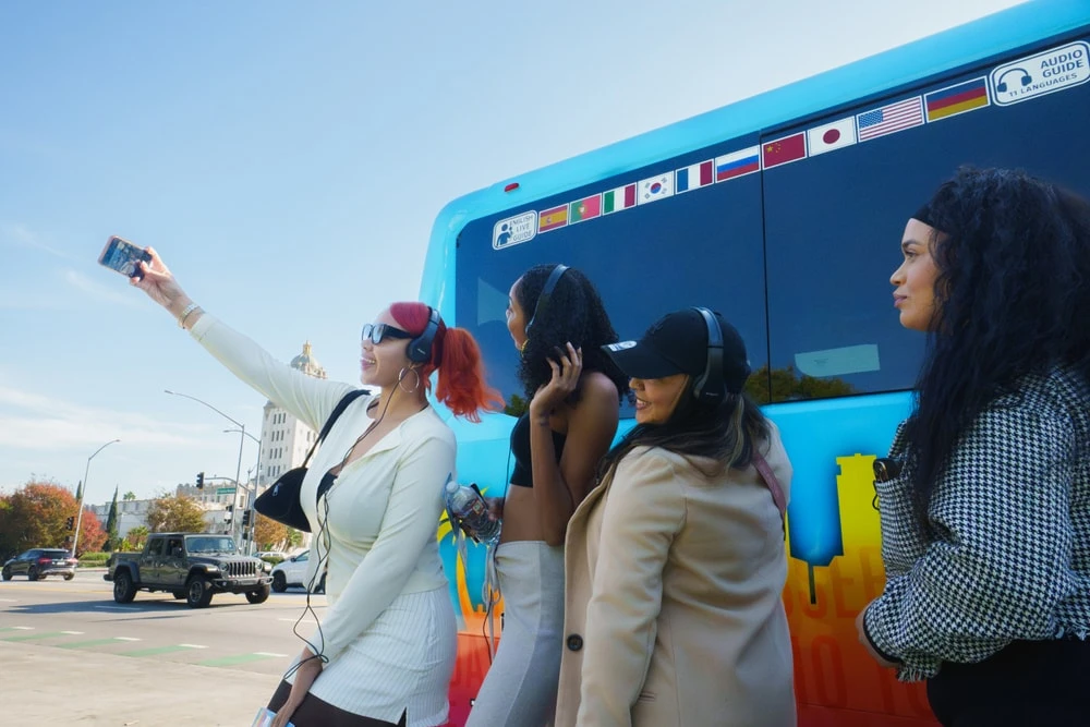 Tour group standing outside Hollywood bus tours colorful vehicle