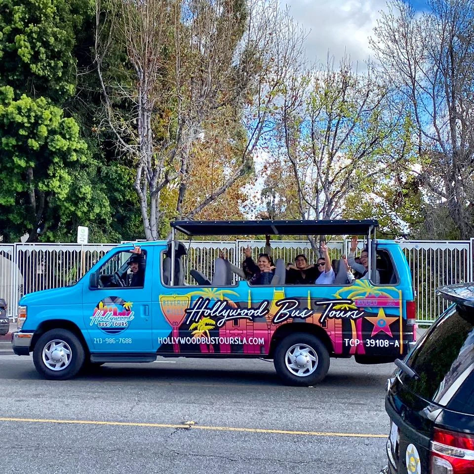 Hollywood Bus Tours open-air sightseeing van with tourists in Los Angeles Title: Hollywood Bus Tours Vehicle