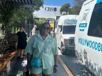 tourist standing near Hollywood Bus Tours van outside CBS studios