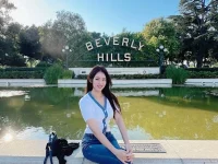 Griffith Observatory building with visitors on the lawn