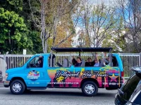 Hollywood Bus Tours open air sightseeing bus with tourists waving in Los Angeles