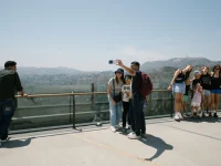 tourists taking selfie at Hollywood Hills overlook Los Angeles