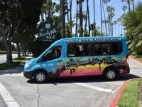 Hollywood Bus Tours van near Beverly Hills Hotel entrance palm trees