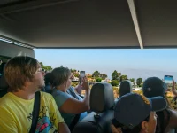 tourists riding open air Hollywood sightseeing bus tour