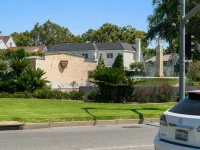 Beverly Hills fountain landmark surrounded by gardens and palm trees