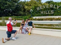 family taking photos at Beverly Hills sign landmark park