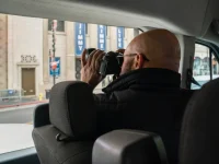 photographer inside Hollywood tour van taking photos of Hollywood Boulevard