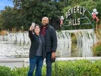couple taking selfie at Beverly Hills sign landmark