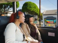 tourist using audio guide headphones on Hollywood bus tour