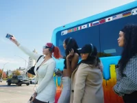 tourists posing outside Hollywood Bus Tours vehicle in Los Angeles