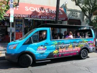 Hollywood bus tour vehicle on Hollywood Boulevard with tourists