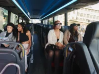 tourists enjoying sightseeing ride inside Hollywood bus tour