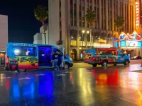 Hollywood Bus Tours van parked on Hollywood Walk of Fame at night