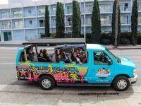 tourists riding open air Hollywood celebrity homes bus tour