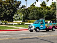 Hollywood Bus Tours vehicle parked on Hollywood Boulevard sidewalk