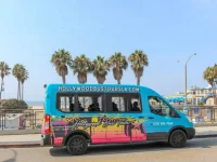 Hollywood Bus Tours vehicle near Beverly Hills street sign