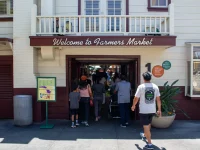 entrance to Los Angeles Farmers Market with visitors walking inside