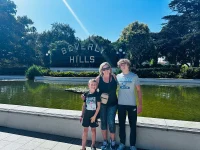 family posing at Beverly Hills sign landmark