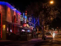 Hollywood nightlife street with neon lights and restaurants