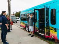 Hollywood Bus Tours vehicle parked while guide photographs guests
