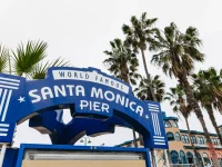 Santa Monica Pier entrance sign with palm trees
