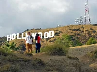 tourists standing near Hollywood sign viewpoint during sightseeing tour