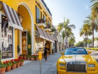 luxury shopping street Rodeo Drive Beverly Hills with yellow sports car