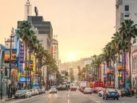 sunset view of Hollywood Boulevard with theaters and palm trees